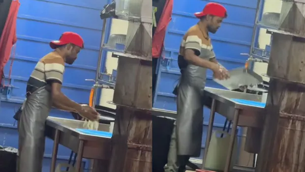 Worker washing leftover food